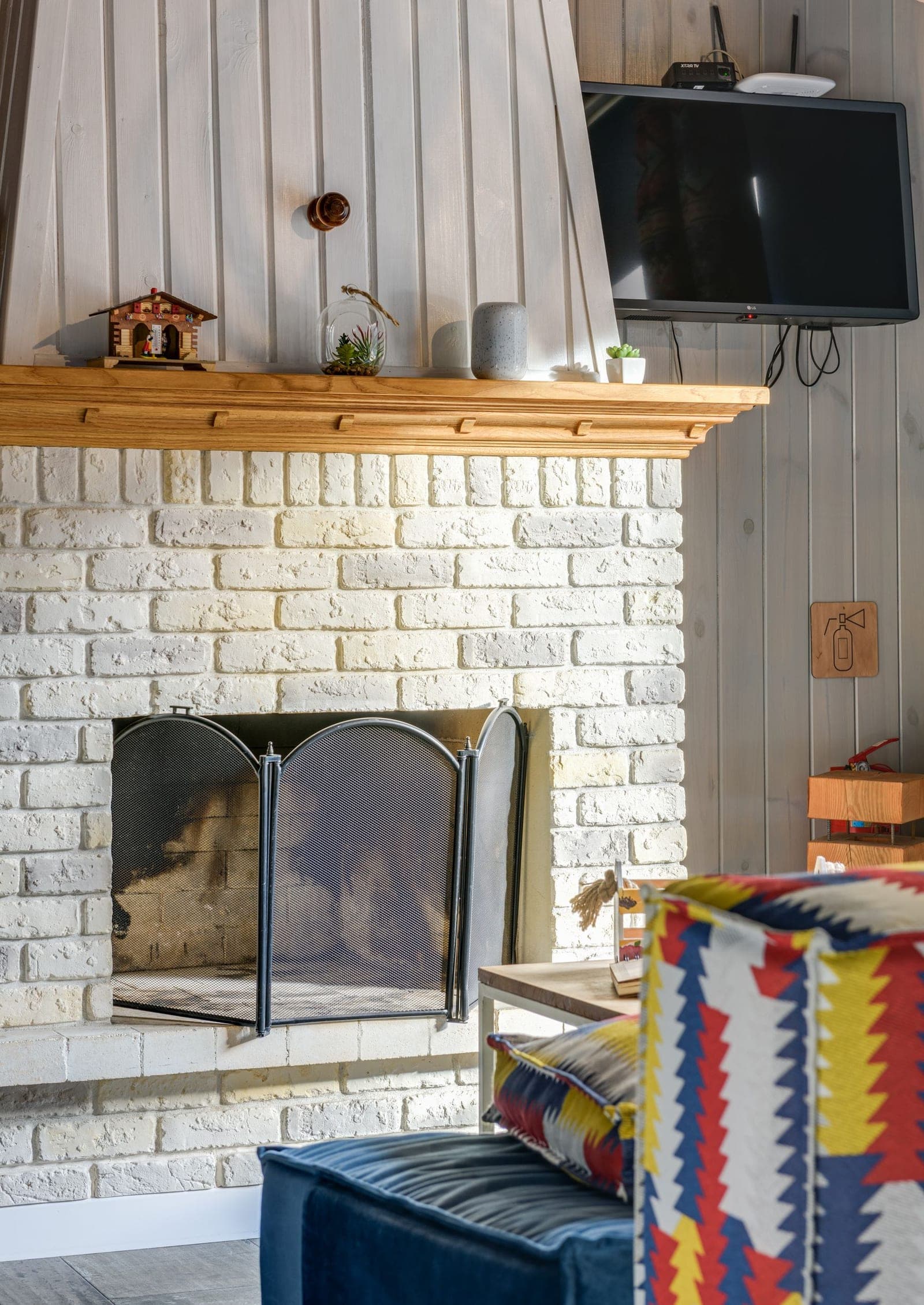 Outdoor TV mounted on a brick patio wall