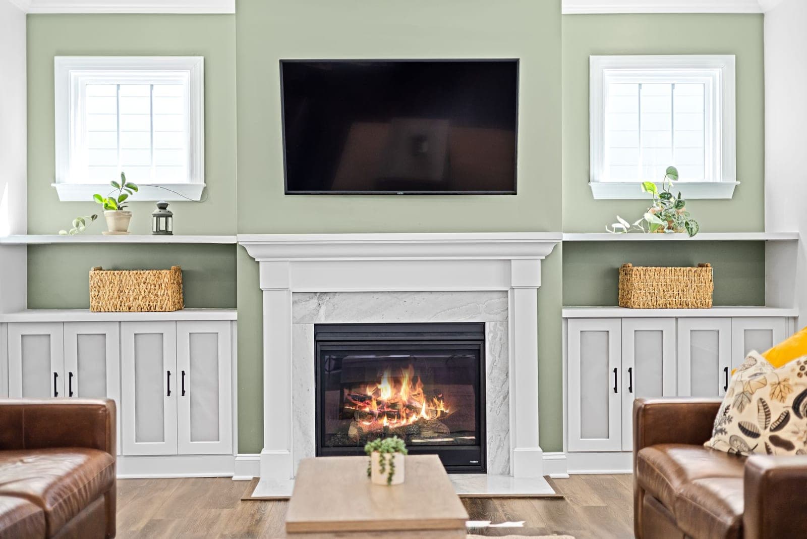 TV mounted above a white fireplace mantel with a soundbar in an Austin home