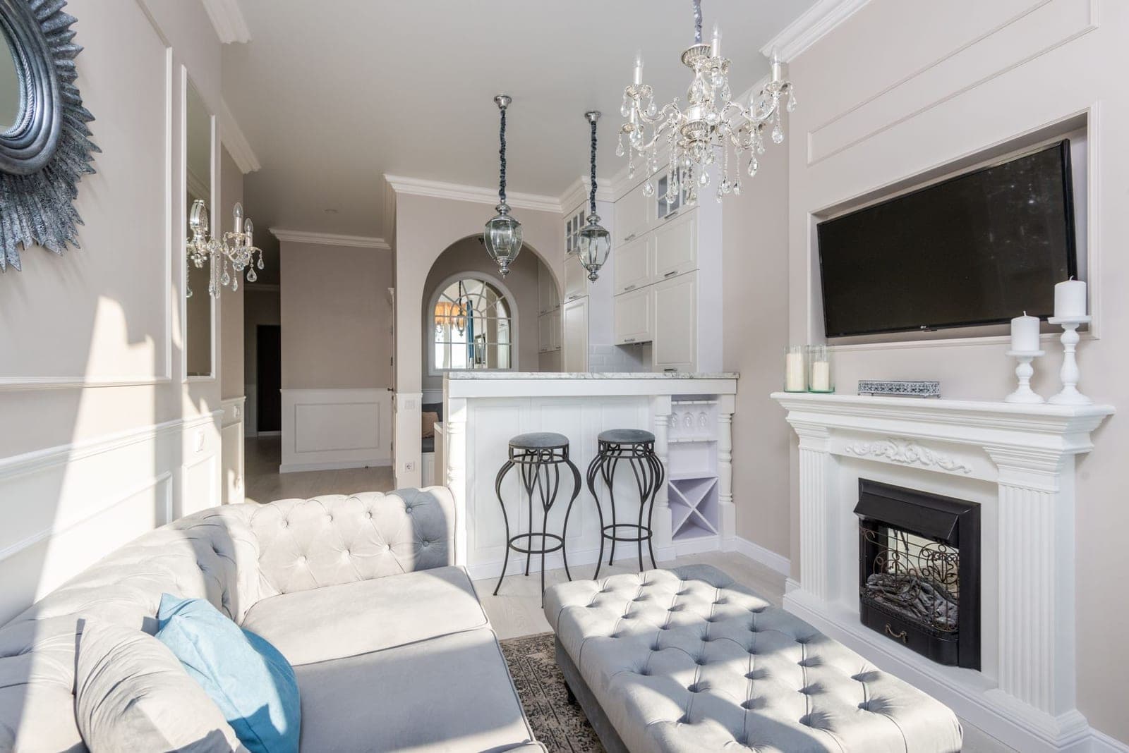 TV mounted over a cast stone fireplace between built-in shelves