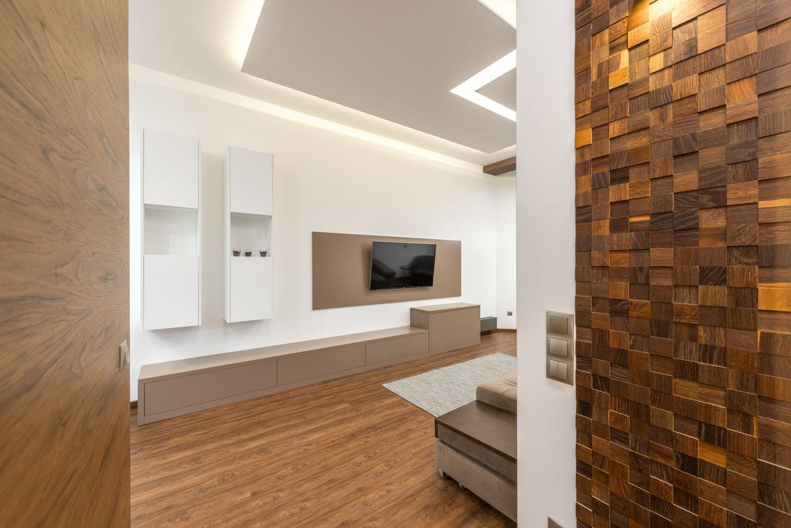 TV mounted inside a dark built-in media wall
